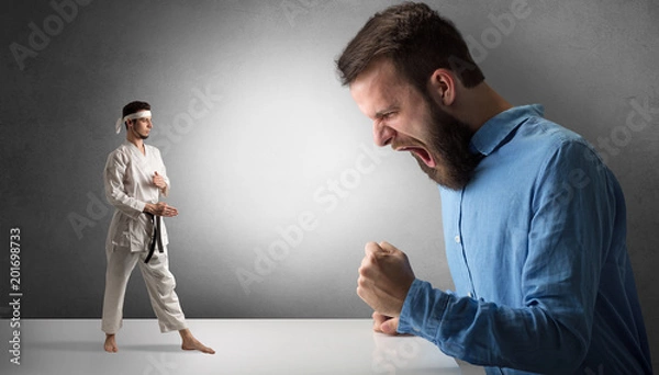 Fototapeta Giant hipster man yelling at a small karate man