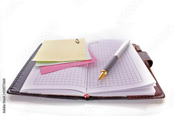 Fototapeta Open notebook with a pen on white
