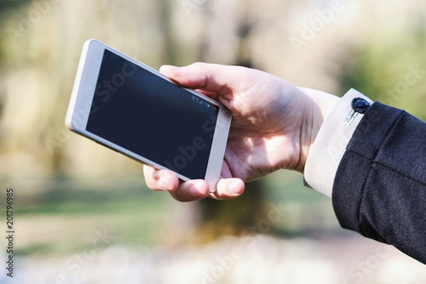 Obraz Woman using her smartphone