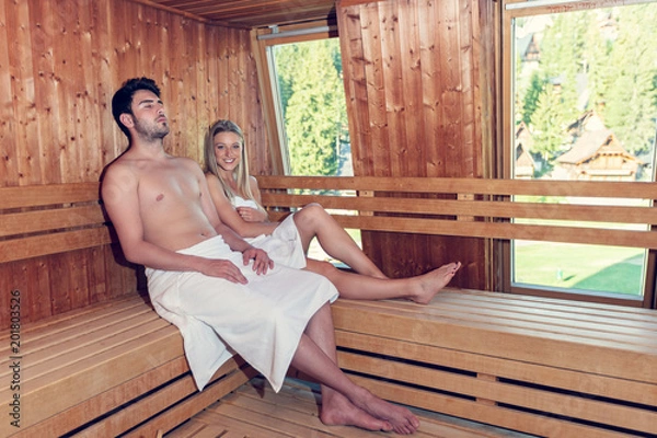Fototapeta Happy couple enjoying the sauna together at the spa