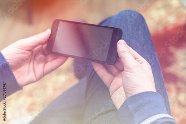 Obraz Closeup photo of man hold and watching video on smartphone, horizontal orientation.