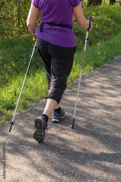 Fototapeta lady nordic walking in springtime park