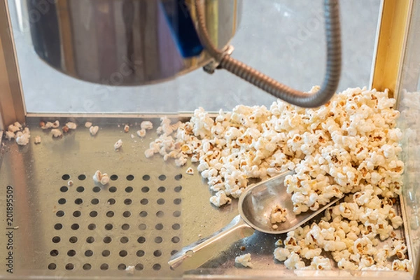 Fototapeta popcorn in a box machine and spoon