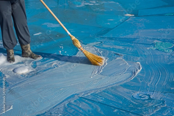 Fototapeta worker cleans the bottom of a large pool