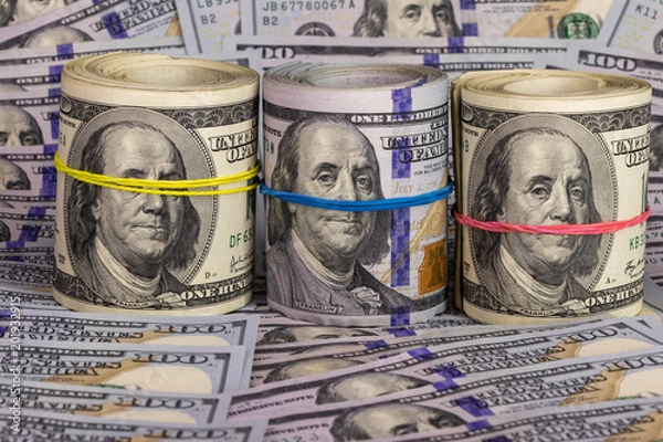 Fototapeta hundred dollar bills, background. three bundles of dollars are collected with colored rubber bands. I do not see anything, I hear nothing, I will not tell anyone.