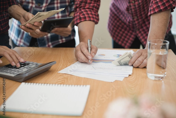 Fototapeta Group business man and woman use calculator. She is calculated the share of business