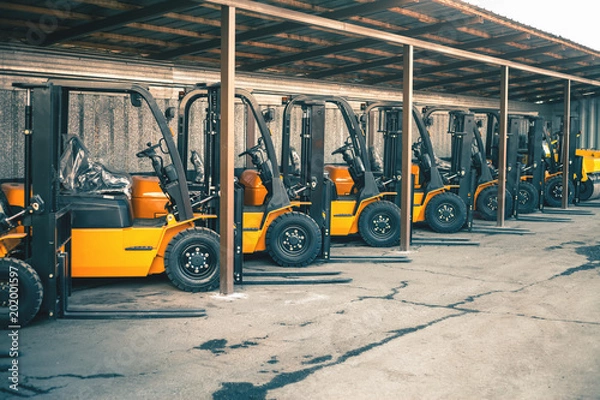 Obraz Background of a lot of forklifts, reliable heavy loader, truck