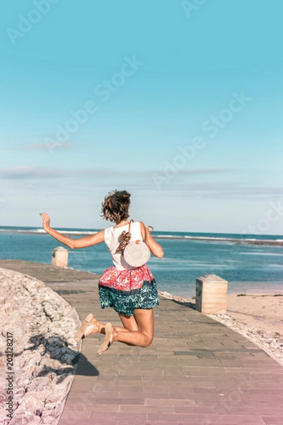 Obraz Woman with fashionable stylish rattan bag and silk scarf outside. Tropical island of Bali, Indonesia. Rattan handbag and silk scarf.