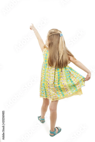 Obraz Back view of adorable little girl pointing at wall. Rear view. Isolated on white background