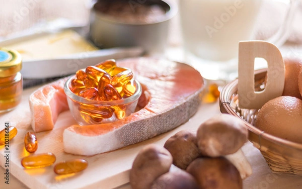 Obraz Natural source of vitamin D in Salmon, eggs, mushroom, fortified milk, margarine, canned tuna and fish oil capsule on wooden texture and background, healthcare and supplemental concept