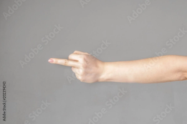 Fototapeta Woman hand showing middle finger on a white isolated background