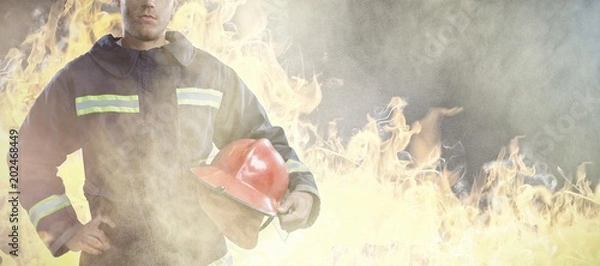 Fototapeta Composite image of serious fireman
