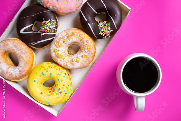 Fototapeta Coffee and appetizing doughnuts.