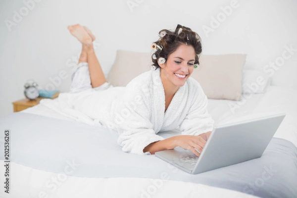 Obraz Cheerful natural brunette using laptop