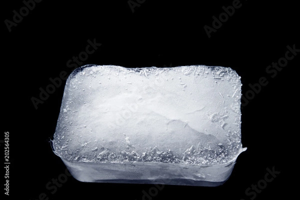 Fototapeta Ice Block / Ice is water frozen into a solid state. Depending on the presence of impurities. it can appear transparent or a more or less opaque bluish-white color. 