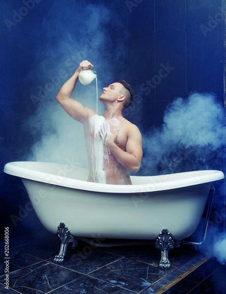 Obraz  man taking a bath with milk