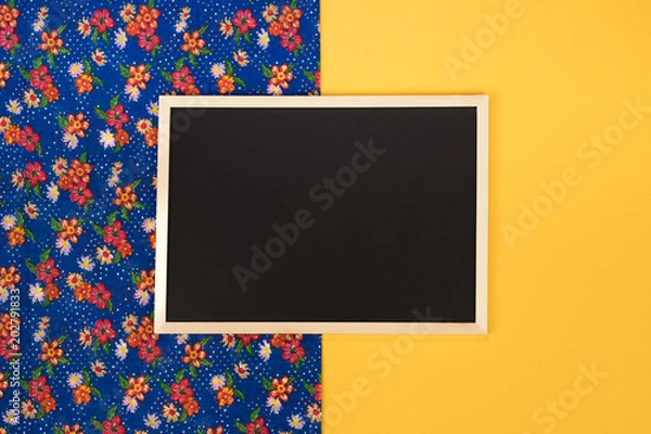 Obraz Empty chalkboard on yellow background with copy space.