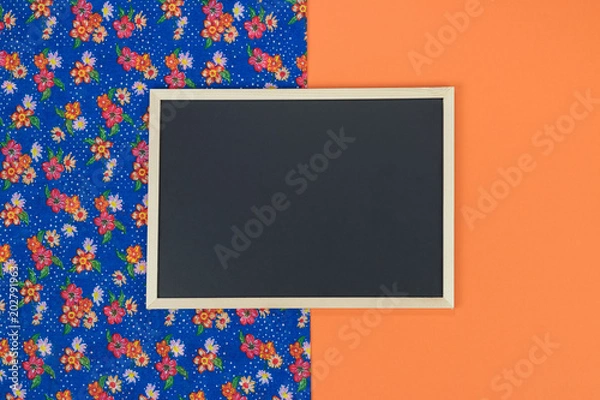 Obraz Empty chalkboard on orange background with copy space.