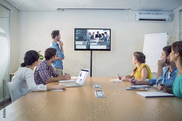 Fototapeta Business interface against attentive business team following a presentation