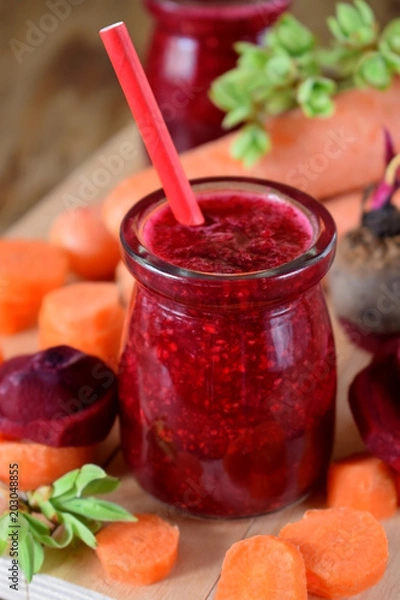 Fototapeta Red smoothie made of carrot and beet in a glass jar