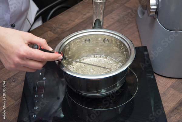 Fototapeta caramel cooking saucepan on the table in the kitchen