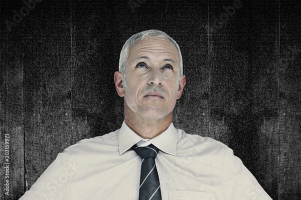 Obraz Businessman thinking against black background