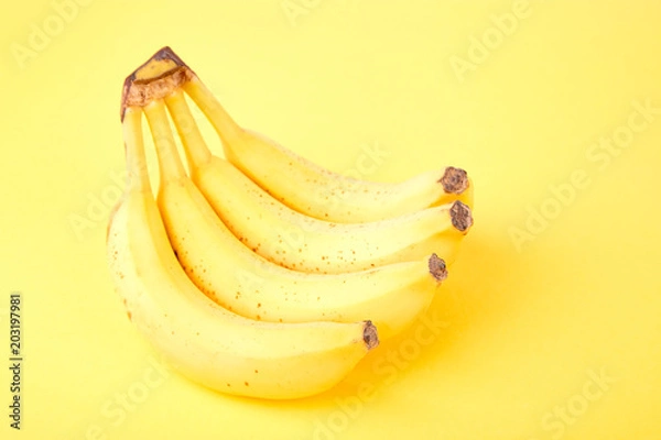 Fototapeta Banana on yellow paper background.