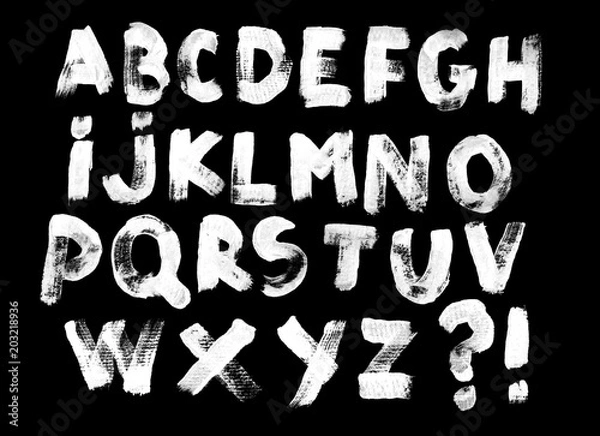 Fototapeta Alphabet set of white capital handwritten letters on a black background. Drawn by semi-dry brush with unpainted areas.
