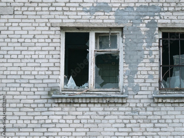 Fototapeta Abandoned brick building with broken window