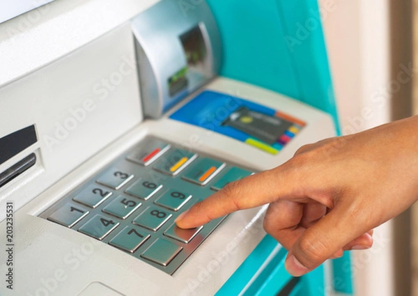 Fototapeta Enter ATM code,Withdrawing money from an ATM,Enter the code on the ATM keyboard,pass code on ATM,press bank matchine keypad