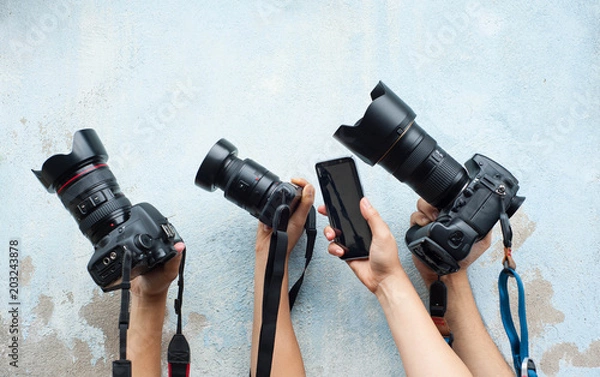 Fototapeta Technology of camera,Development of camera,various camera on the blue wall,Hold hands with favorite camera