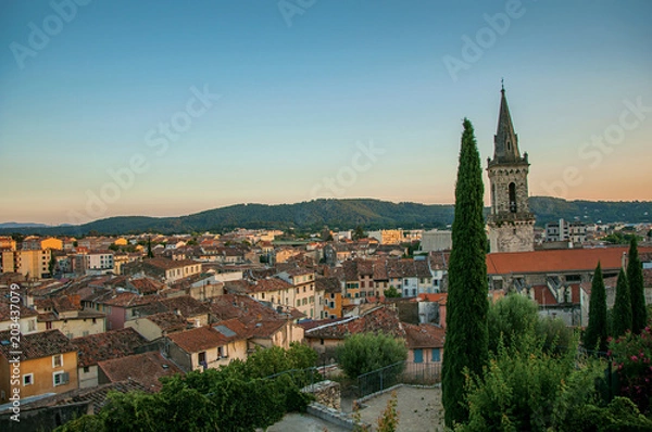 Fototapeta View of the graceful town of Draguignan from the hill of the clock tower under the colorful light of the sunset. Located in the Provence region, Var department, southeastern France