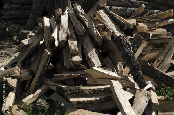 Fototapeta Cut logs fire wood. Renewable resource of energy. Environmental concept. Pile of chopped fire wood prepared for winter, ready for burning