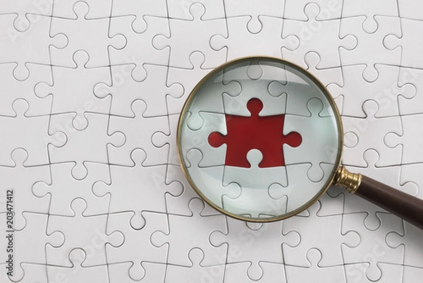 Fototapeta Magnifying glass searching missing puzzle peace 