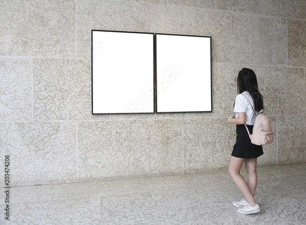 Obraz Woman in a gallery looking at empty frames