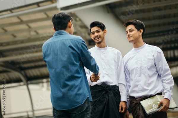 Obraz Asian guy advice map to Myanmar travellers in Bangkok city