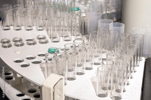 Obraz Glass vials for liquid samples. Laboratory equipment for dispensing fluid samples.