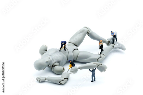 Fototapeta Miniature people : engineers working on electronics components and fixing broken robot