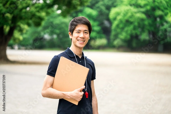 Fototapeta 笑顔の男性コーチ