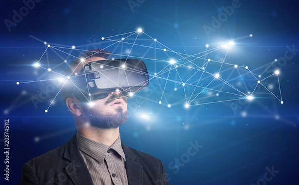 Fototapeta Amazed businessman with virtual reality network concept in front of him