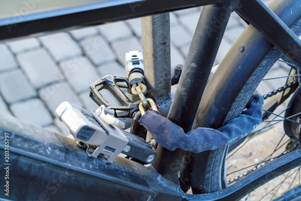 Obraz Electric bike, chained with several strong locks and chains