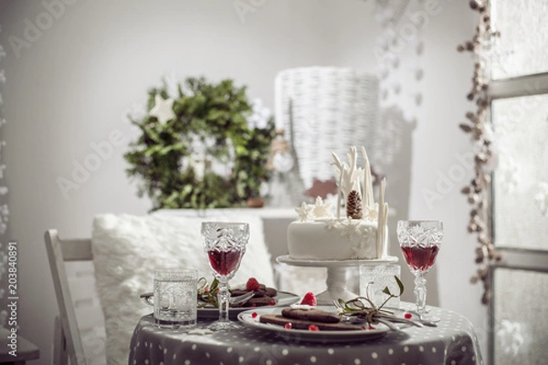 Fototapeta Table for two with white cake, chocolate biscuits and red wine