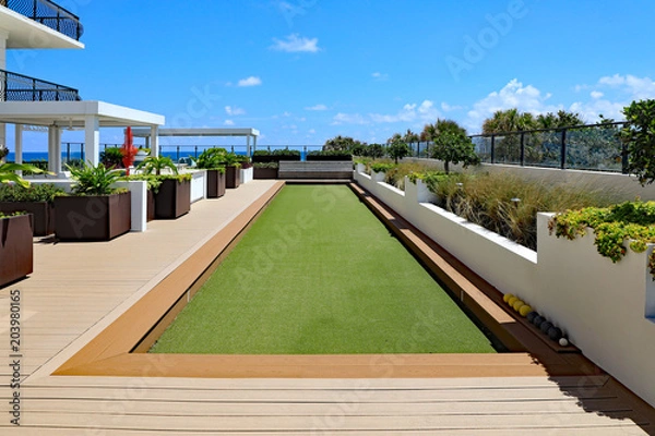 Obraz Inviting upscale bocce ball court with artificial turf, on a rooftop terrace.
