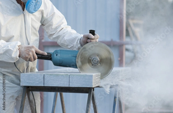 Obraz Worker cuts stone grinding machine