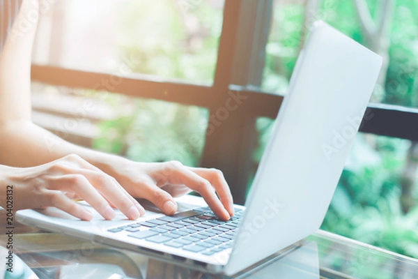 Fototapeta Business woman hand working with a laptop computer in the office.