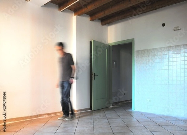 Obraz Inside the room during renovations with blurred worker figure. Architectural background.