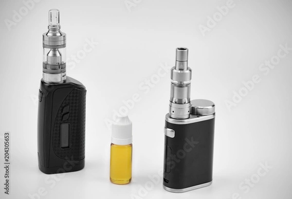 Fototapeta E - cigarette for vaping , technical devices.The liquid in the bottle 