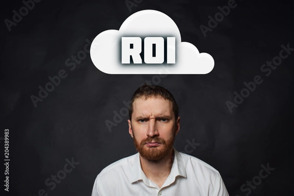Obraz Above the businessman hangs a cloud with the inscription:ROI