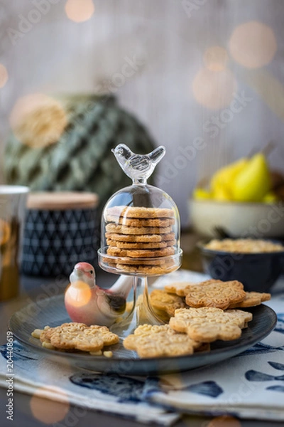 Fototapeta On the plate is a curly cookie with decorative patterns made with a wooden rolling pin