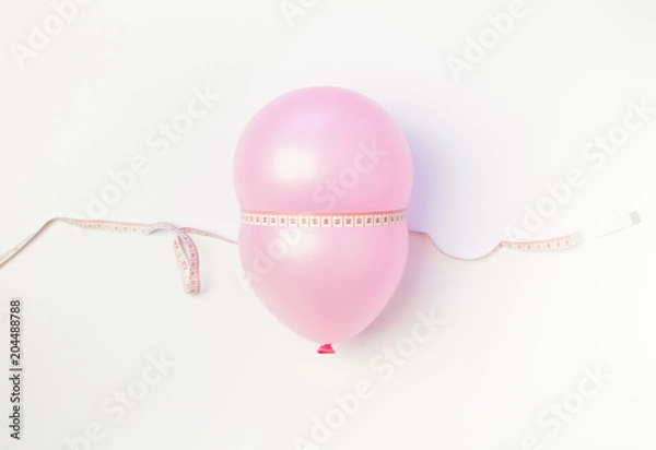 Obraz Balloon tied measuring tape on white background. Weight loss, slim body, healthy lifestyle concept. The waist measurement.